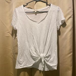 Plain white v-neck, with tie a tie in front.